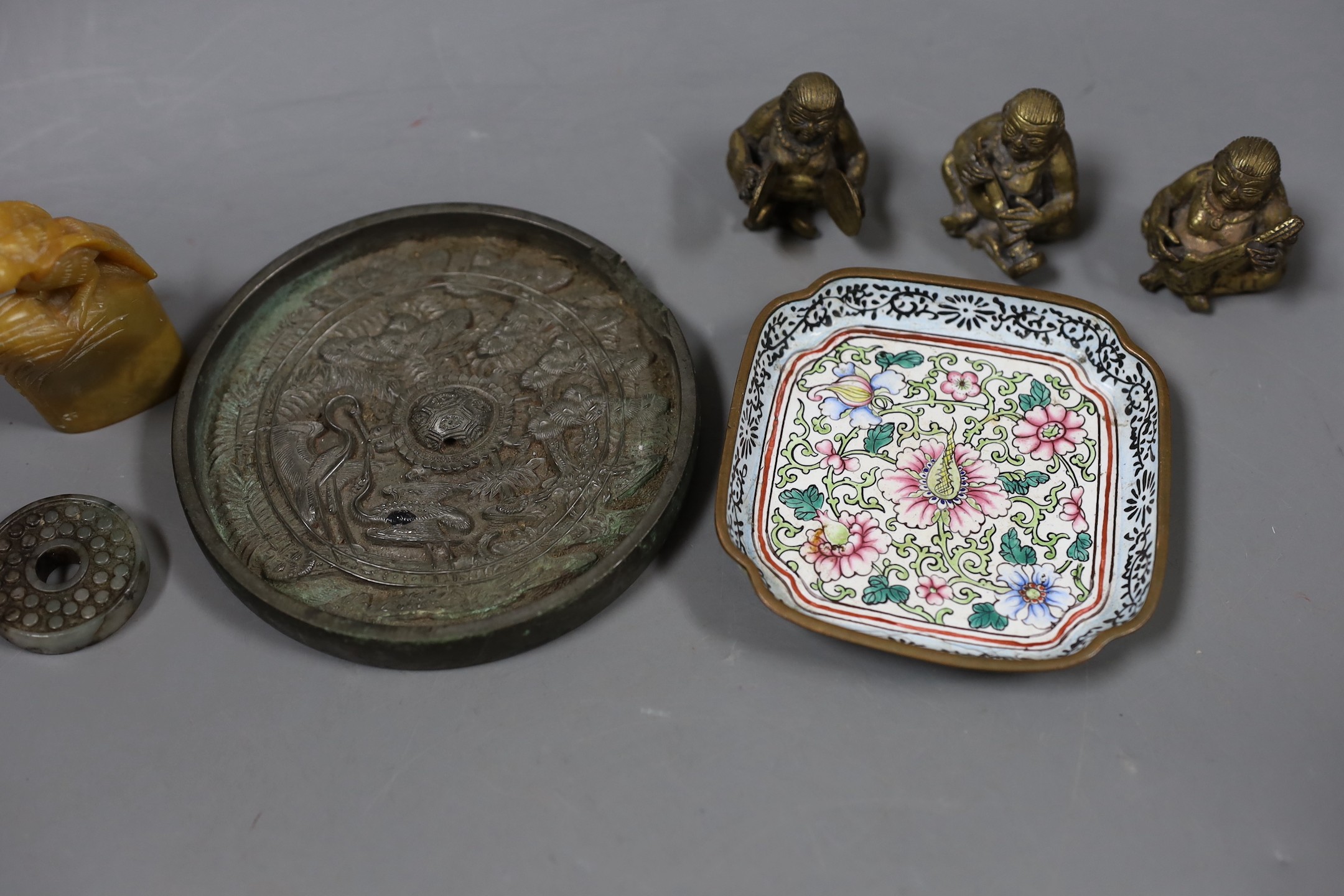 A group of assorted Chinese items to include jade bi disc, a Canton enamel dish, a bronze mirror, a soapstone seal, etc.